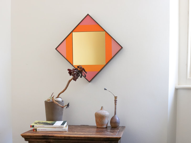 Hand made square wall mirror in gold with orange and pink panels with studio pottery 